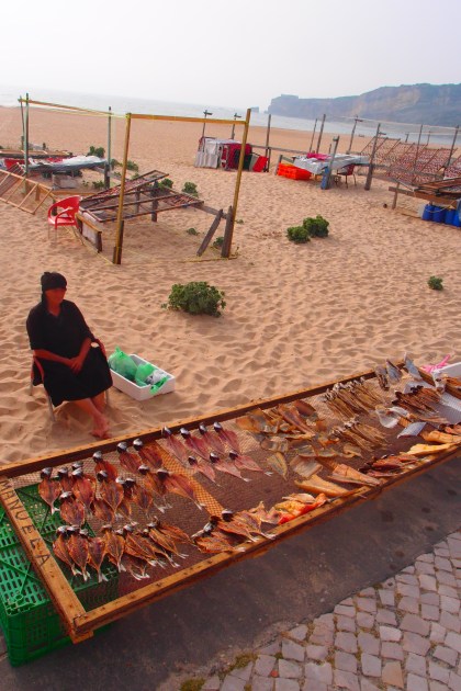 Grandma selling various dried fish in Nazare
